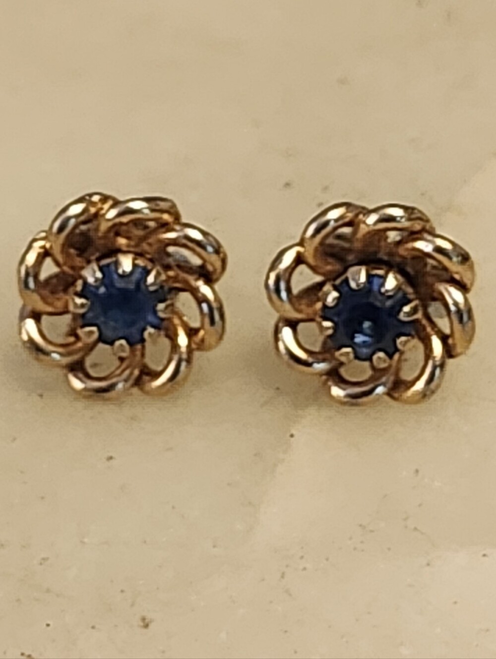 Gold Tone Floral Twist Stud Earrings with Blue Center Stone